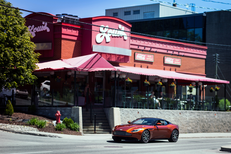 Illustration for article titled Chasing Canada's Greasiest People's Food In A $200,000 Aston Martin
